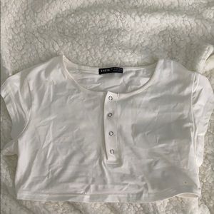 a white crop top. you can show cleavage or not.